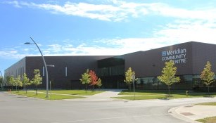 exterior of meridian community centre, trees and grass
