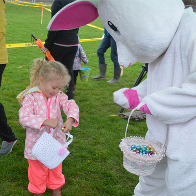 person in easter bunny suit and small child
