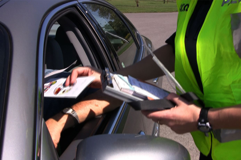 ticket being handed through car window
