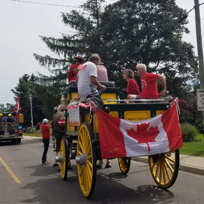 canada flag on back of horse drawn buggy