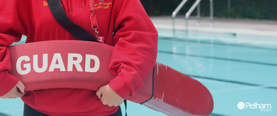 lifeguard standing infront of pool