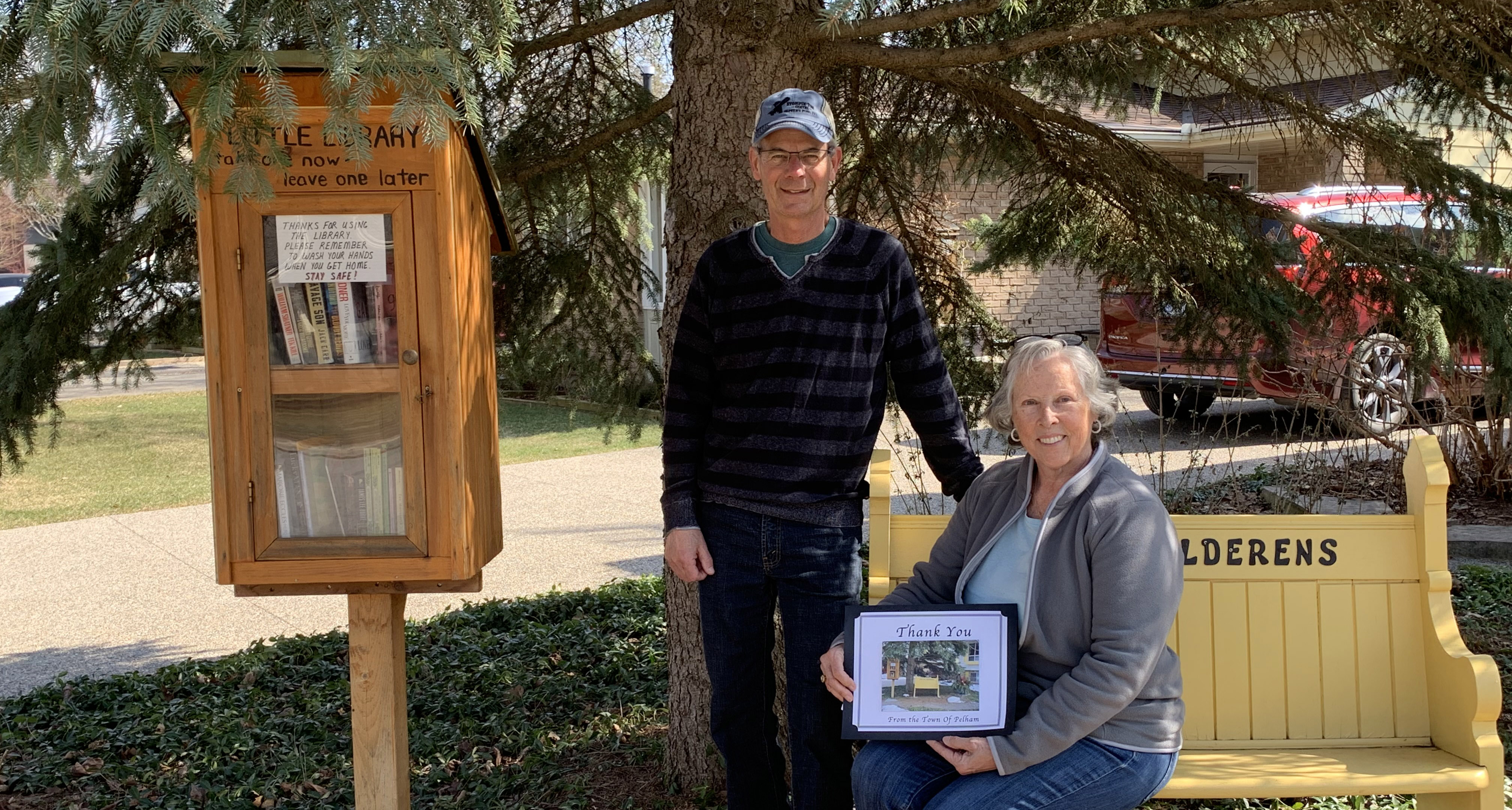 people in front of little library 