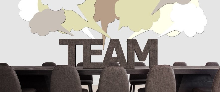 word team on table with speech bubbles above